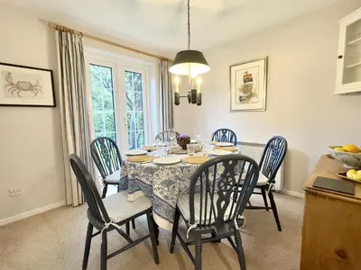 a dining room with a table and chairs at Choughs in Saint Minver