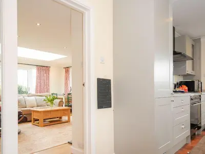 a room with a kitchen and a living room at Chimings in Wadebridge