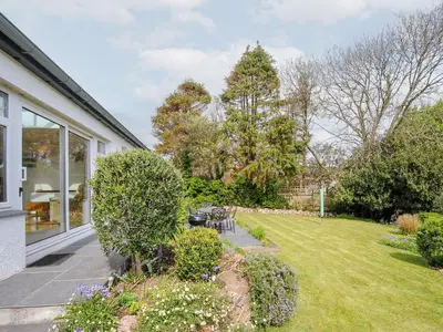 a house with a garden with a lawn at Chimings in Wadebridge