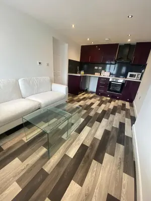 a living room with a couch and a glass table at Spacious 1-Bed Apartment - Sleeps 2 & Parking in Truro