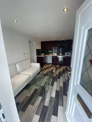 a living room with a white couch and a glass table at Spacious 1-Bed Apartment - Sleeps 2 & Parking in Truro
