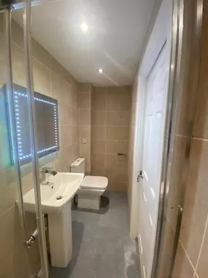 a bathroom with a toilet and a sink and a shower at Spacious 1-Bed Apartment - Sleeps 2 & Parking in Truro