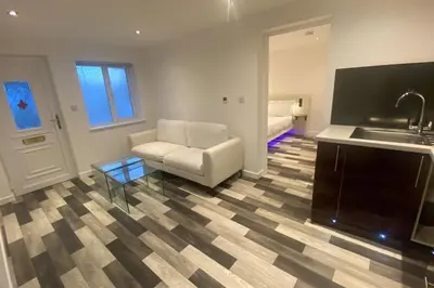a living room with a couch and a sink at Spacious 1-Bed Apartment - Sleeps 2 & Parking in Truro