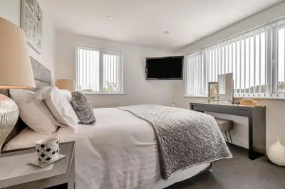 a bedroom with a bed and a desk and a television at 2 Bed in Newquay oc-b32399 in Holywell Bay