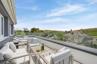 a balcony with white chairs and a view of the countryside at 2 Bed in Newquay oc-b32399 in Holywell Bay