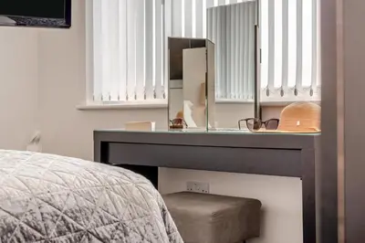 a bedroom with a dressing table and a mirror at 2 Bed in Newquay oc-b32399 in Holywell Bay