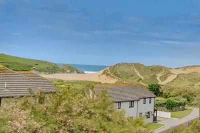 a group of houses on a hill next to a beach at 2 Bed in Newquay oc-b32399 in Holywell Bay