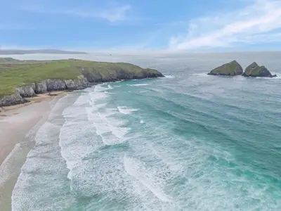 an aerial view of a beach with rocks in the ocean at 2 Bed in Newquay oc-b32399 in Holywell Bay