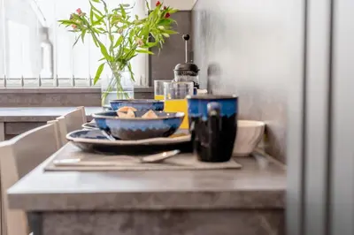 a table with two bowls of food on a counter at 1 Bed in Newquay oc-s32400 in Holywell Bay