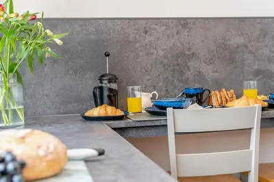 a table with bread and orange juice and a chair at 1 Bed in Newquay oc-s32400 in Holywell Bay