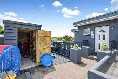 a tiny house with a garage on a balcony at 1 Bed in Newquay oc-s32400 in Holywell Bay