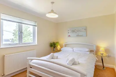 a white bed in a room with a window at 2 Bed in St. Issey oc-a32428 in Saint Issey