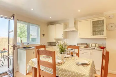 a kitchen with a table and chairs in a kitchen at 2 Bed in St. Issey oc-a32428 in Saint Issey