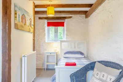 a small bedroom with a bed and a window at 2 Bed in Fowey oc-d32427 in Fowey