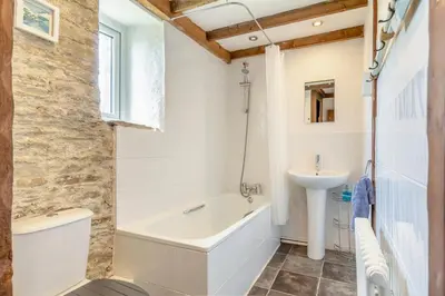a bathroom with a tub and a sink at 2 Bed in Fowey oc-d32427 in Fowey