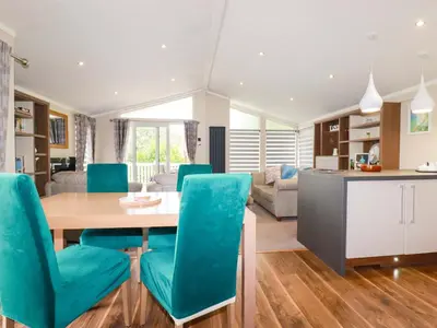 a kitchen and living room with a table and chairs at The Maples 44 in St Austell