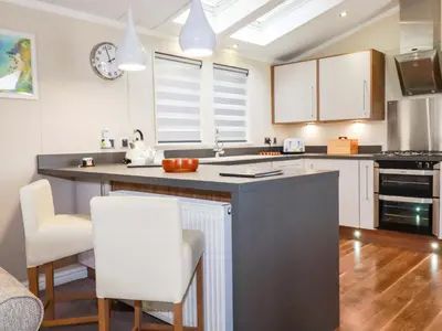a kitchen with a large island in the middle at The Maples 44 in St Austell