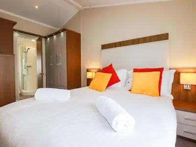 a bedroom with a large white bed with pillows at The Maples 44 in St Austell