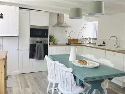 a kitchen with a table with a plate of food on it at Holiday Home Riverside Cottage by Interhome in Lerryn