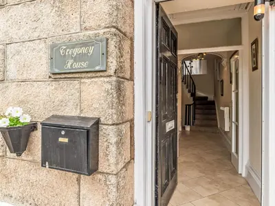 a sign on the side of a house at Holiday Home Tregony House by Interhome in Mevagissey