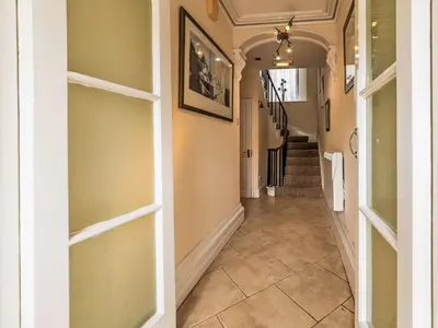 a hallway with a door and a tile floor at Holiday Home Tregony House by Interhome in Mevagissey