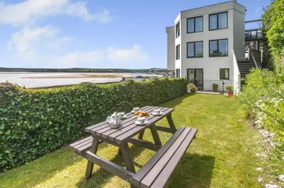 a picnic table in the grass in front of a house at 1 Bed in Padstow oc-t32456 in Padstow
