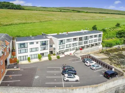 an aerial view of a hotel with cars parked in a parking lot at 1 Bed in Padstow oc-t32456 in Padstow