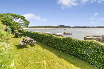 a park with picnic tables and a view of the water at 1 Bed in Padstow oc-t32456 in Padstow