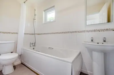 a white bathroom with a toilet and a sink at 2 Bed in Looe oc-g32529 in Looe