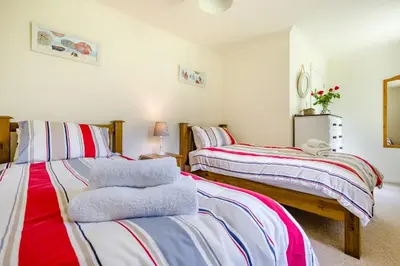 a bedroom with two beds with towels on them at 2 Bed in Looe oc-g32529 in Looe