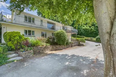 a large house with a balcony on top of it at 2 Bed in Looe oc-g32529 in Looe