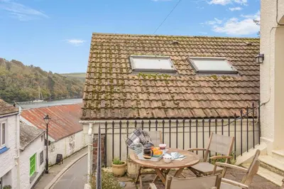 a small patio with a table and chairs on a balcony at 2 Bed in Fowey oc-p00638 in Fowey