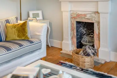 a living room with a couch and a fireplace at 2 Bed in Fowey oc-p00638 in Fowey