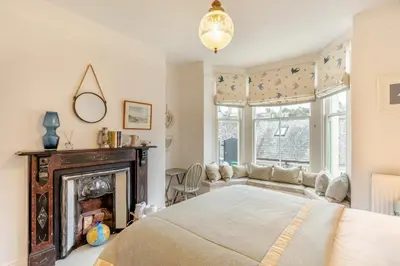 a bedroom with a bed and a fireplace at 2 Bed in Fowey oc-p00638 in Fowey