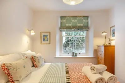 a bedroom with a bed and a window at 2 Bed in Fowey oc-p00638 in Fowey