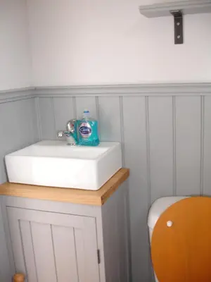 a bathroom sink with a bottle of soap on it at Apple Tree Shepherd's Huts - Blackberry Hut in Saint Endellion