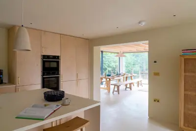 a kitchen with a table and a dining room at The Architects Treehouse in Mount Hawke
