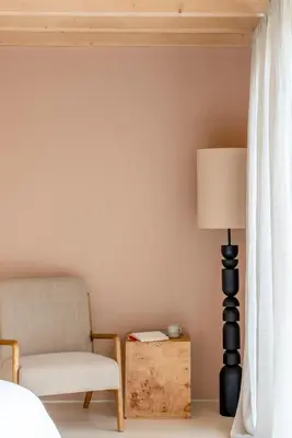 a bedroom with a chair and a lamp at The Architects Treehouse in Mount Hawke