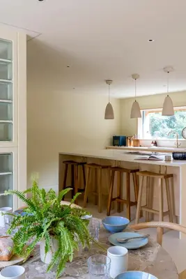 a kitchen with a table and a kitchen island at The Architects Treehouse in Mount Hawke