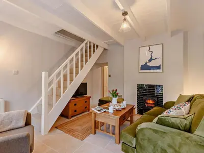 a living room with a couch and a staircase at 2 Bed in Fowey oc-91015 in Polruan