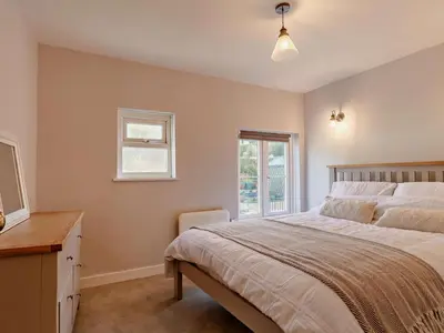a bedroom with a large bed and a window at 2 Bed in Fowey oc-91015 in Polruan