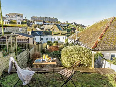 a patio with chairs and a table on a roof at 2 Bed in Fowey oc-91015 in Polruan