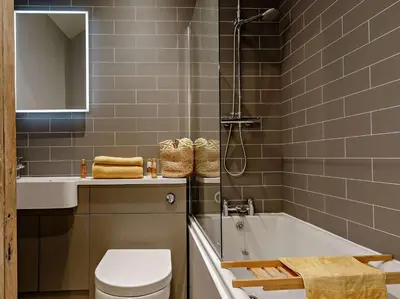 a bathroom with a tub and a toilet and a sink at 2 Bed in Fowey oc-91015 in Polruan