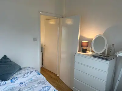 a bedroom with a bed with a mirror and a dresser at 159 Atlantic Bays St Merryn in St Merryn