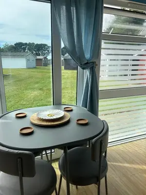 a table and chairs in a room with a window at 159 Atlantic Bays St Merryn in St Merryn