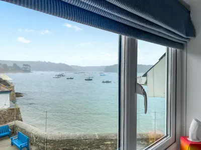 a window with a view of the water at The Watch House in Saint Mawes