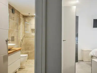 a bathroom with a toilet and a sink at Beach Retreat in Looe