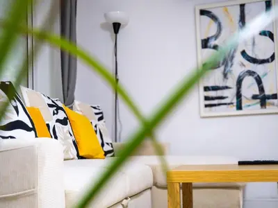 a living room with a white couch and a table at Modern surf pad, steps from Towan beach in Newquay