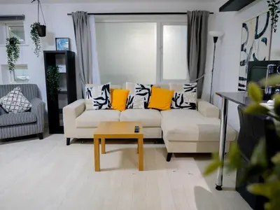 a living room with a couch and a coffee table at Modern surf pad, steps from Towan beach in Newquay