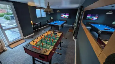 a room with two pool tables and ping pong balls at St Ives Countryside Home with Pool Table & Parking in Towednack
